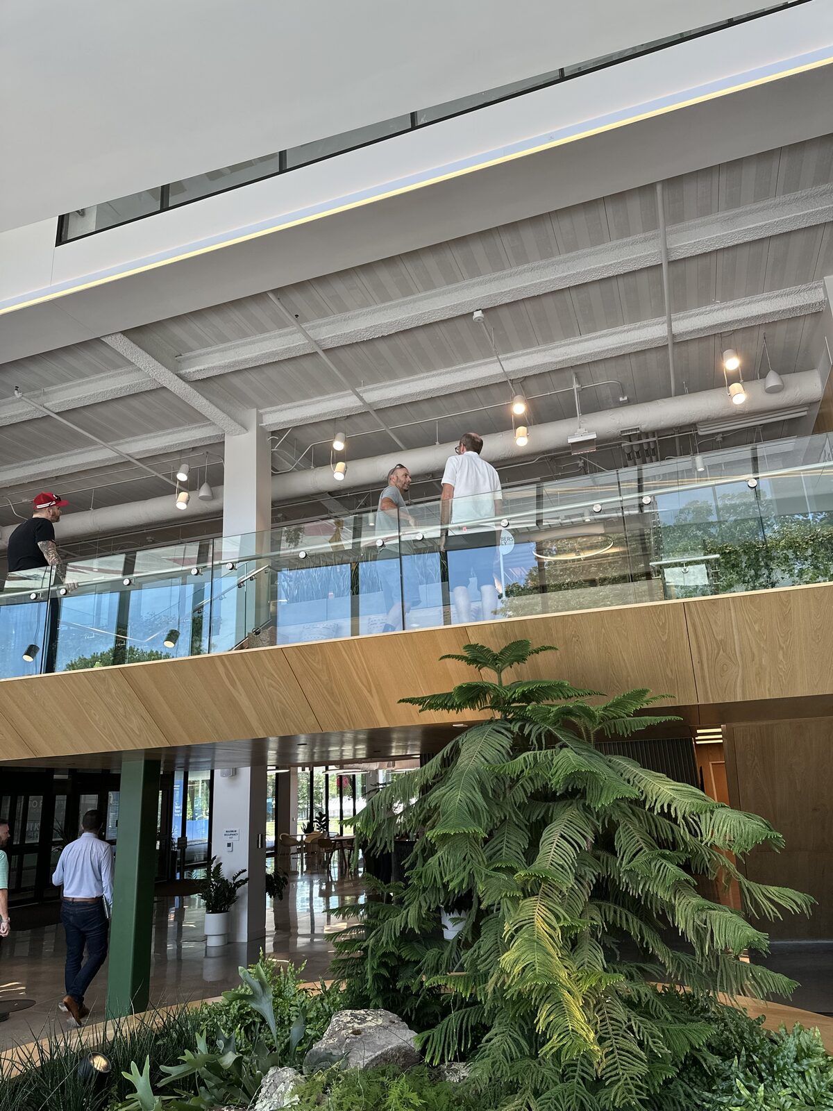An open-air atrium walkway with greenery at a Convivium Living community