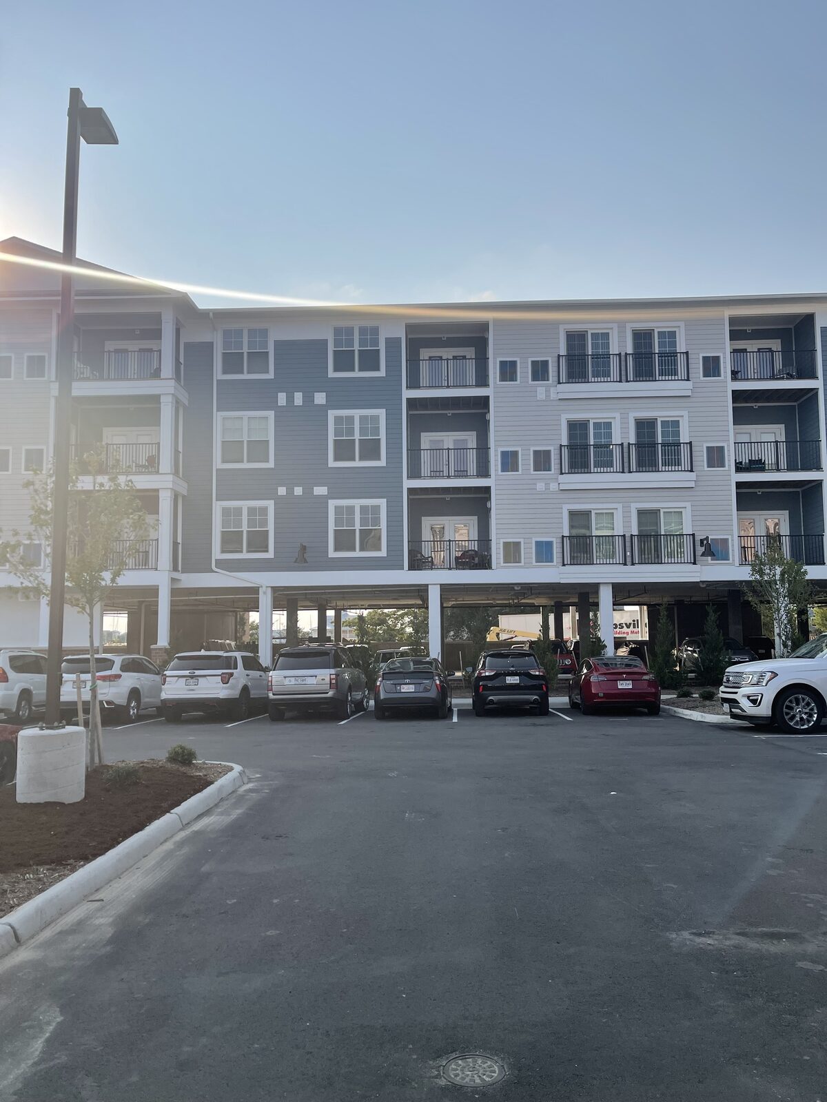 A multifamily apartment building with covered parking at a DanReDev community