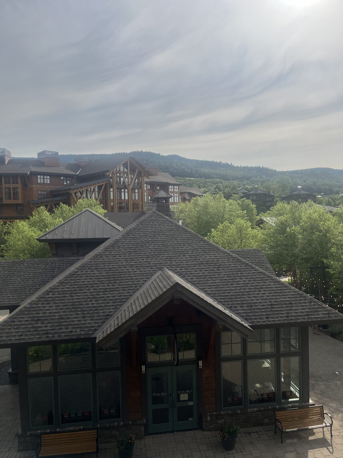 An elevated view of DEK Builds' mountain resort village with timber and stone architecture