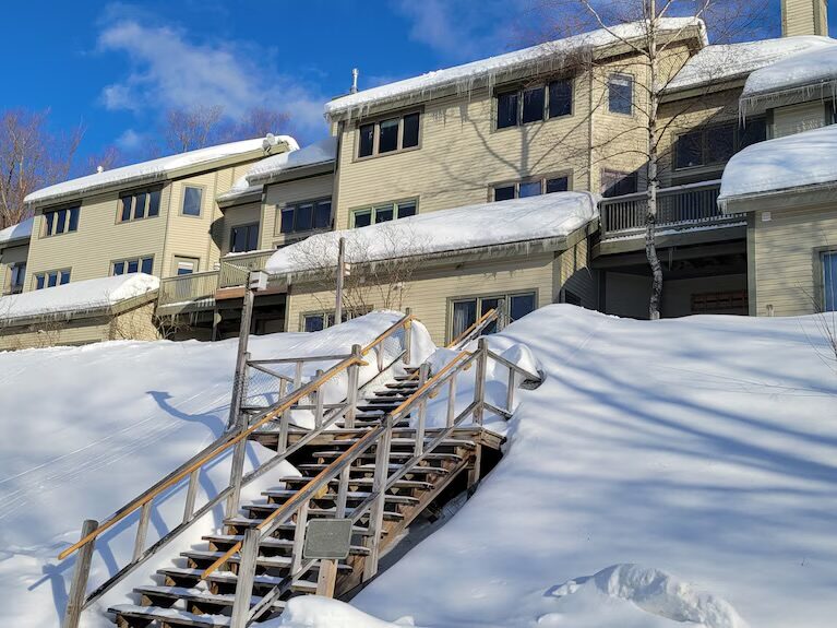 A snow-covered DEK Builds mountain condo building