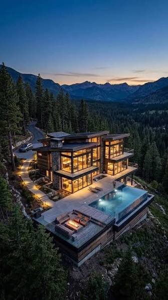 A luxury DEK Builds mountain home at dusk with a pool