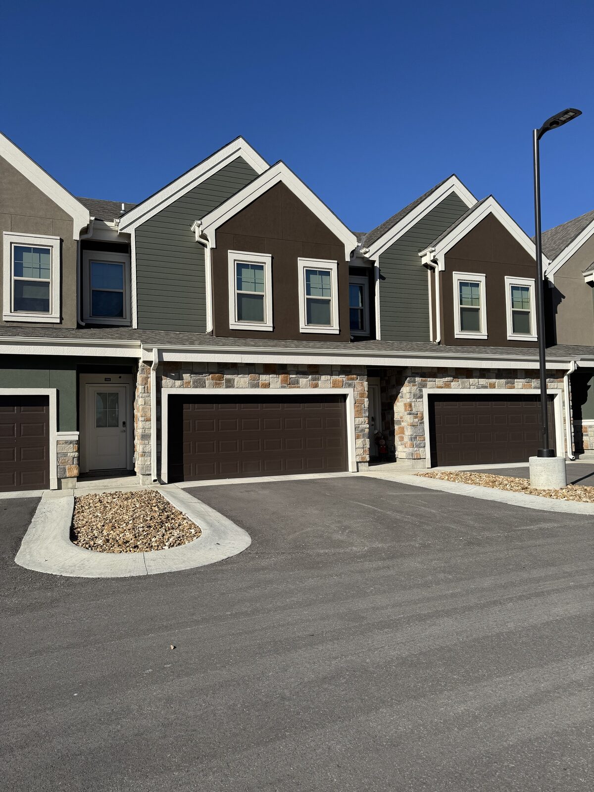 A DK Homes townhome building with stone accents