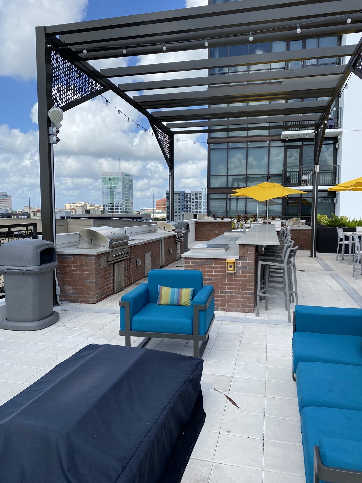 A rooftop amenity lounge overlooking a city skyline