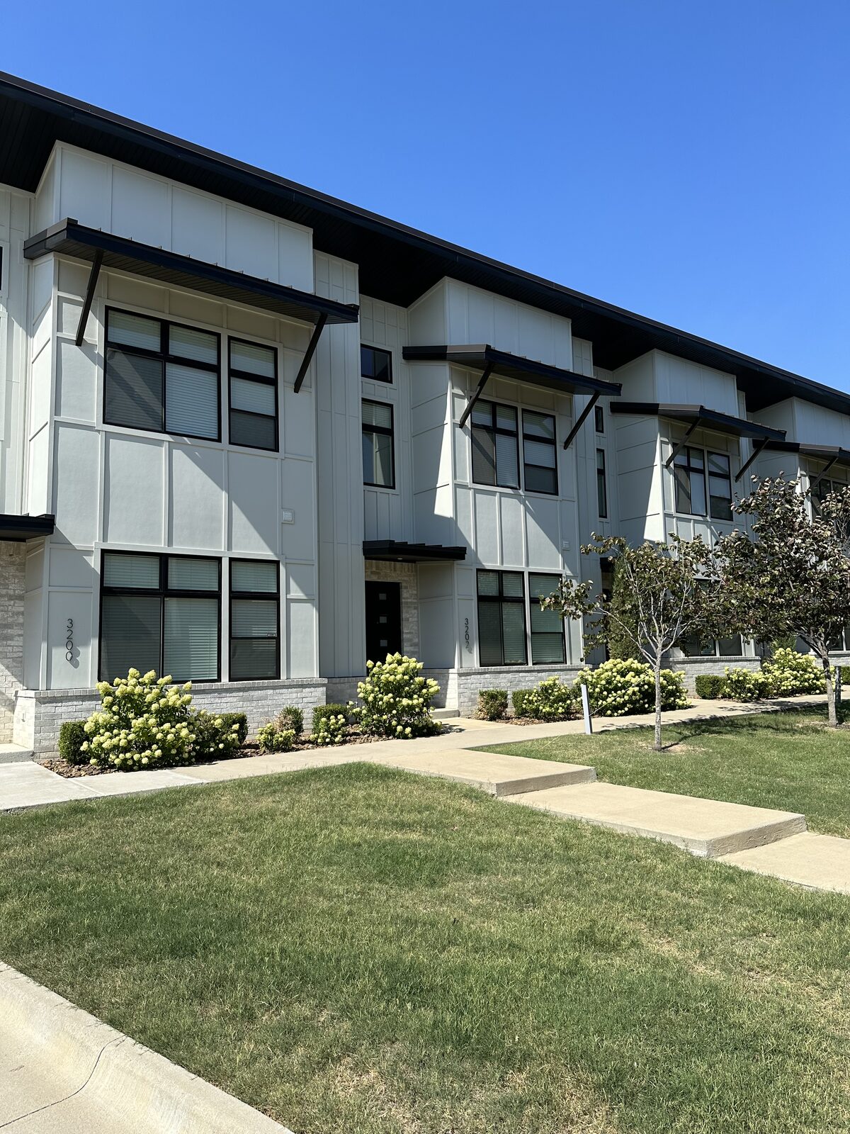 Exterior of a finished modern multi-story townhome building