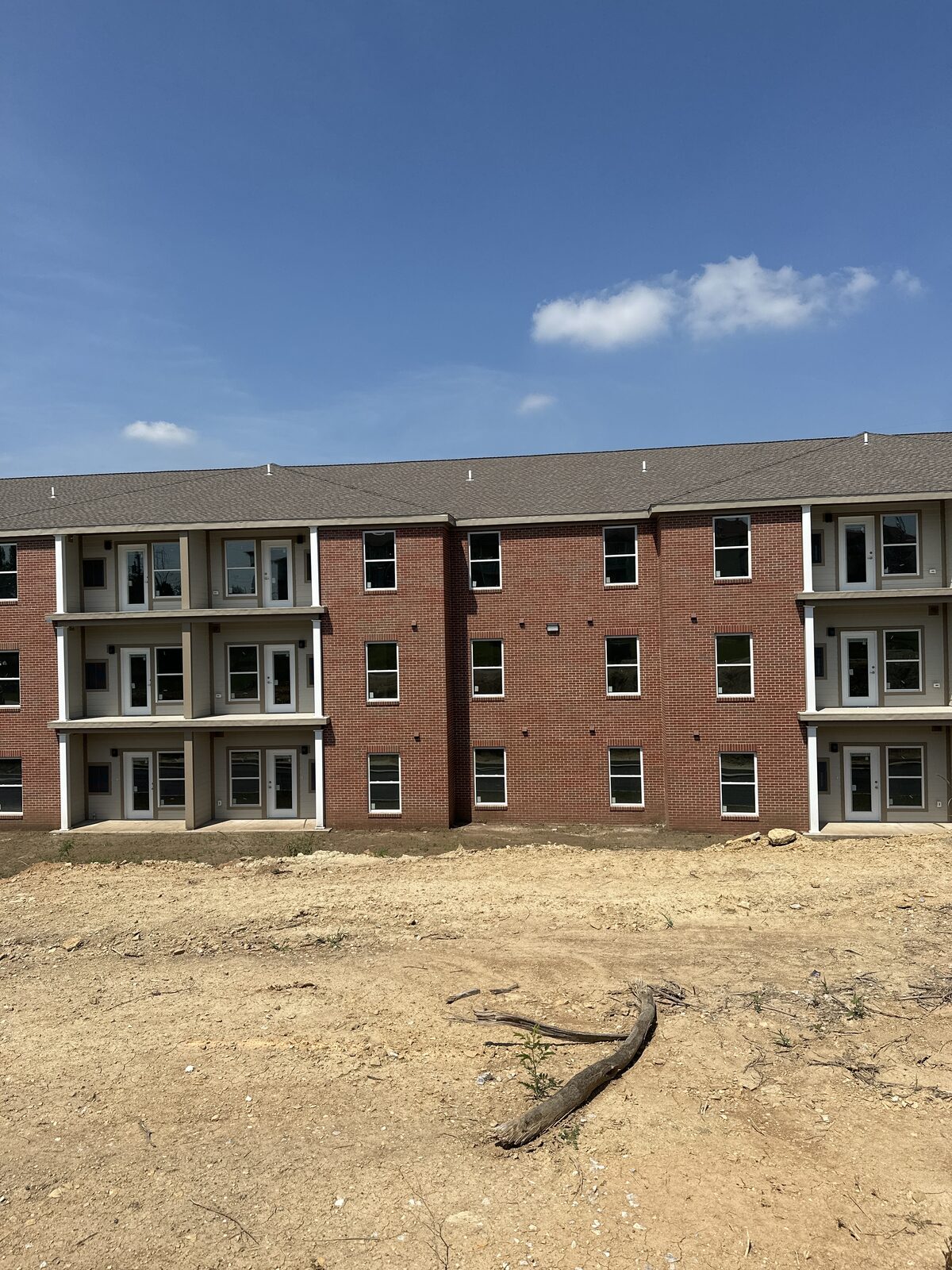 A mid-rise brick apartment building under construction