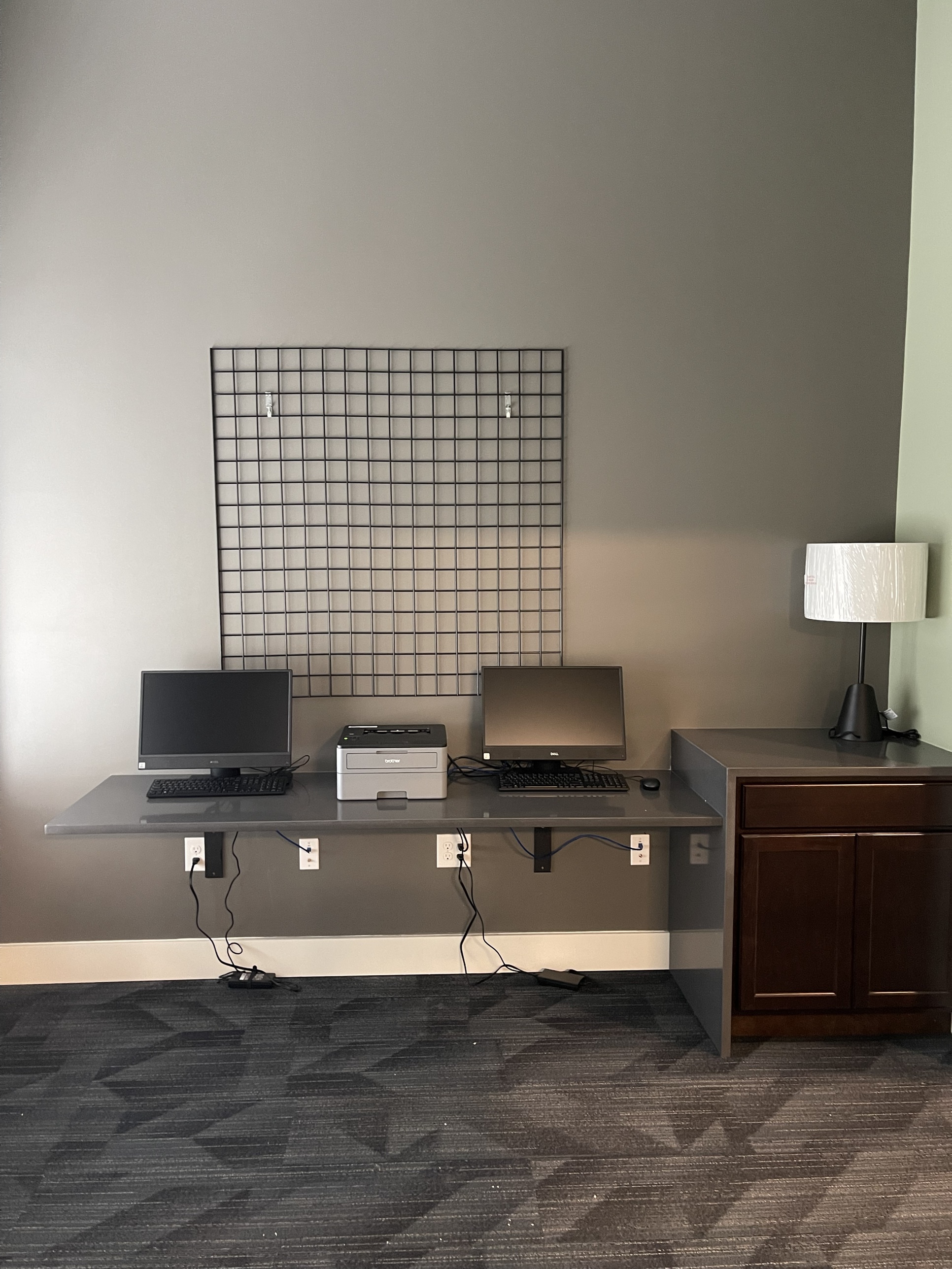The business center with two computer workstations and a printer