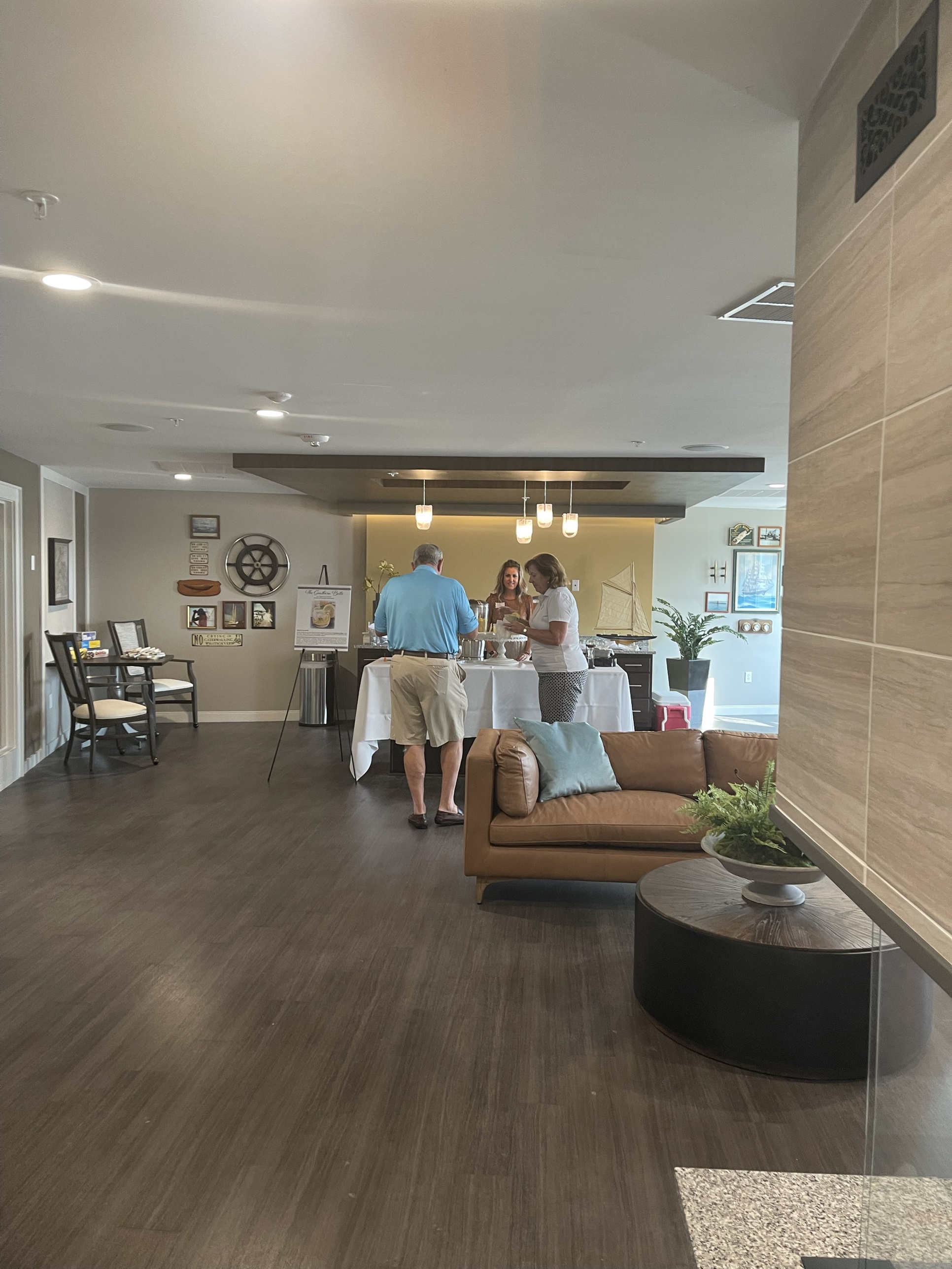 The clubhouse lounge and seating area with nautical-themed decor, set up for a resident event