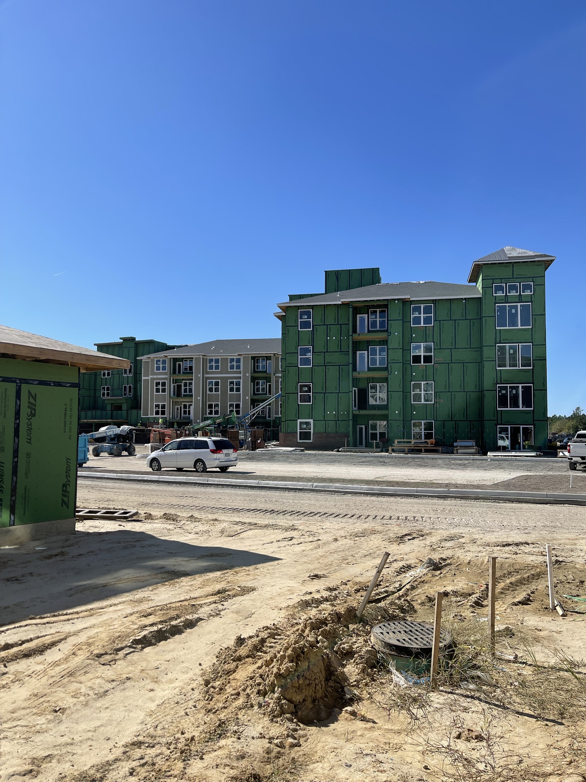 Greenview Residences apartment buildings under construction, wrapped in weather barrier