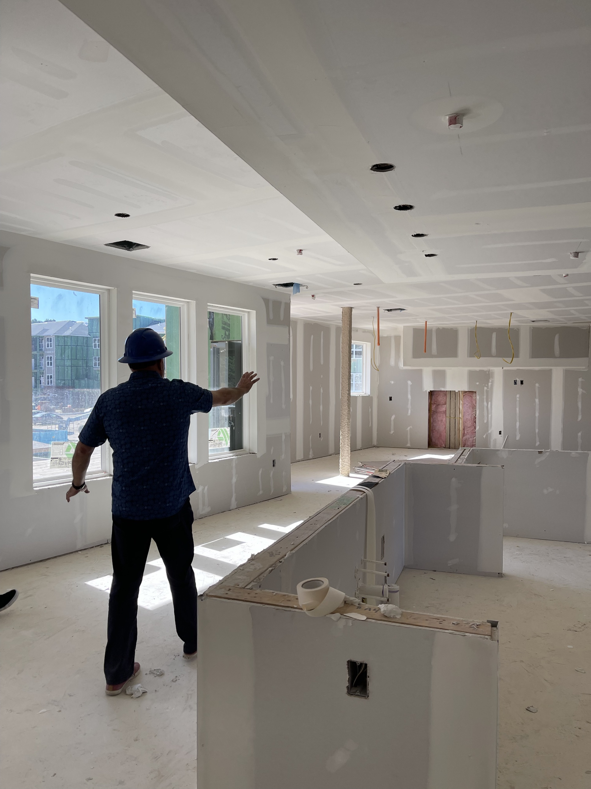 The Kaufman Development team walking the interior of a Greenview Residences building during drywall-stage construction