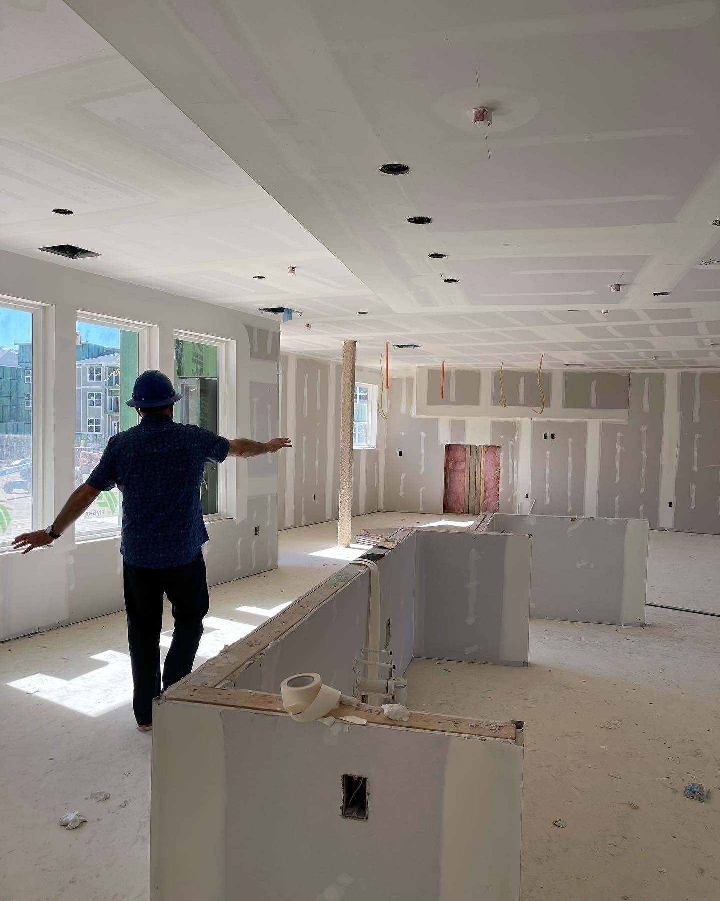 A site visit inside a large unfinished great room at a client project