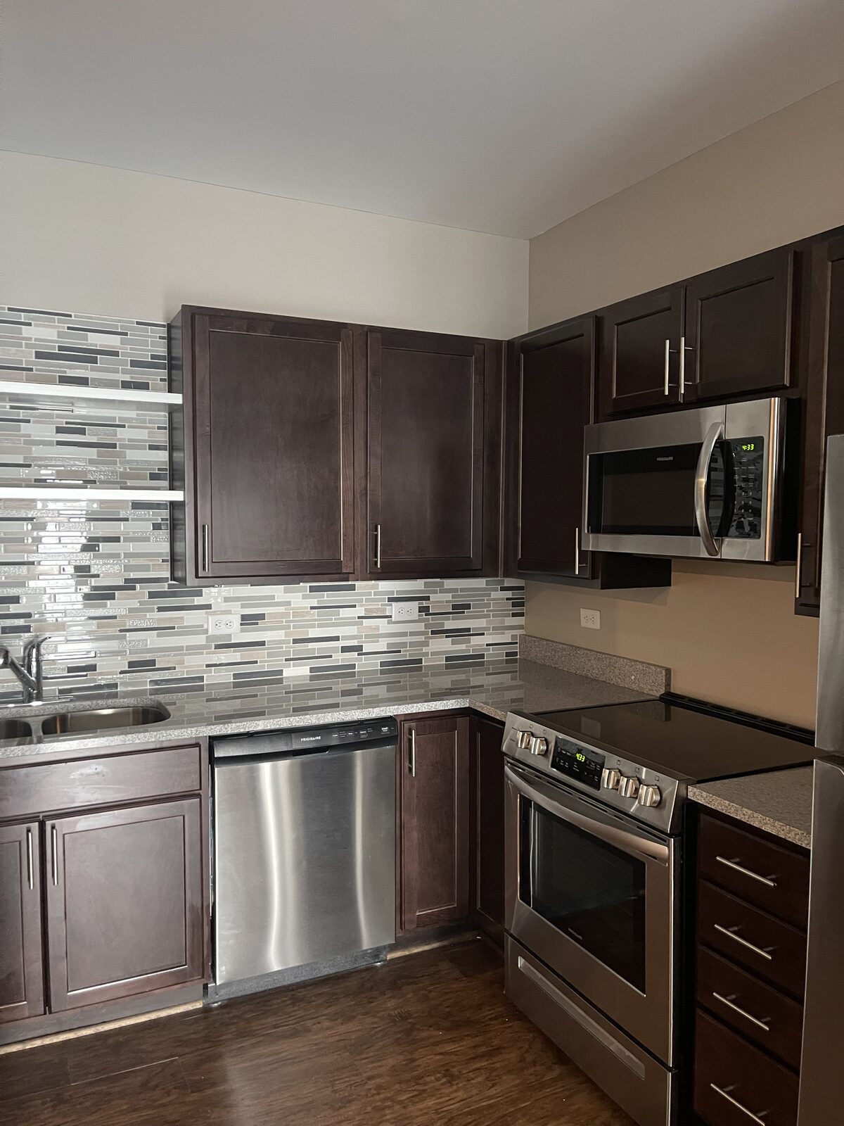 A modern kitchen with stainless steel appliances at a Kaufman Development property