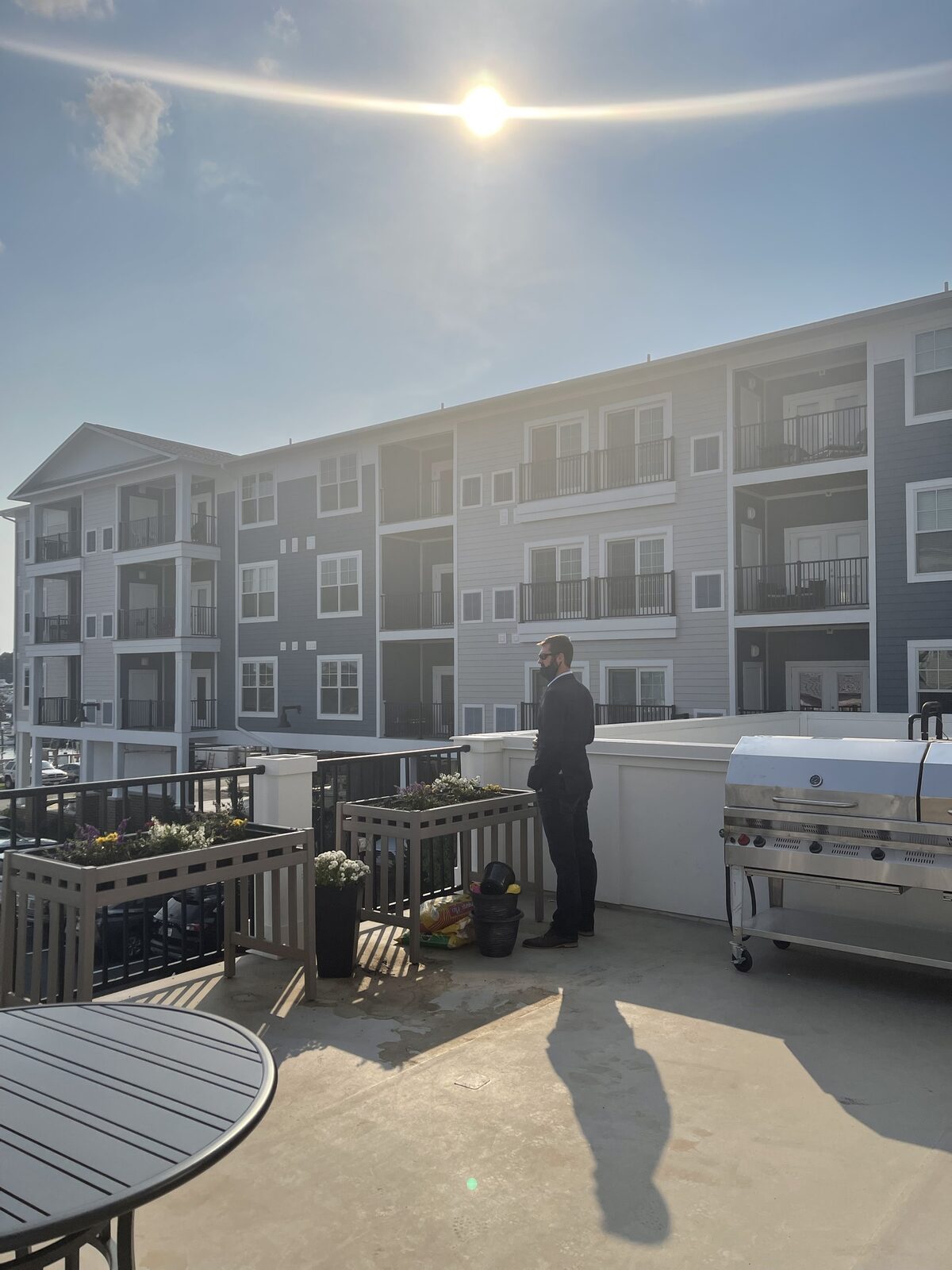 A rooftop terrace with grill and seating at a Kaufman Development property