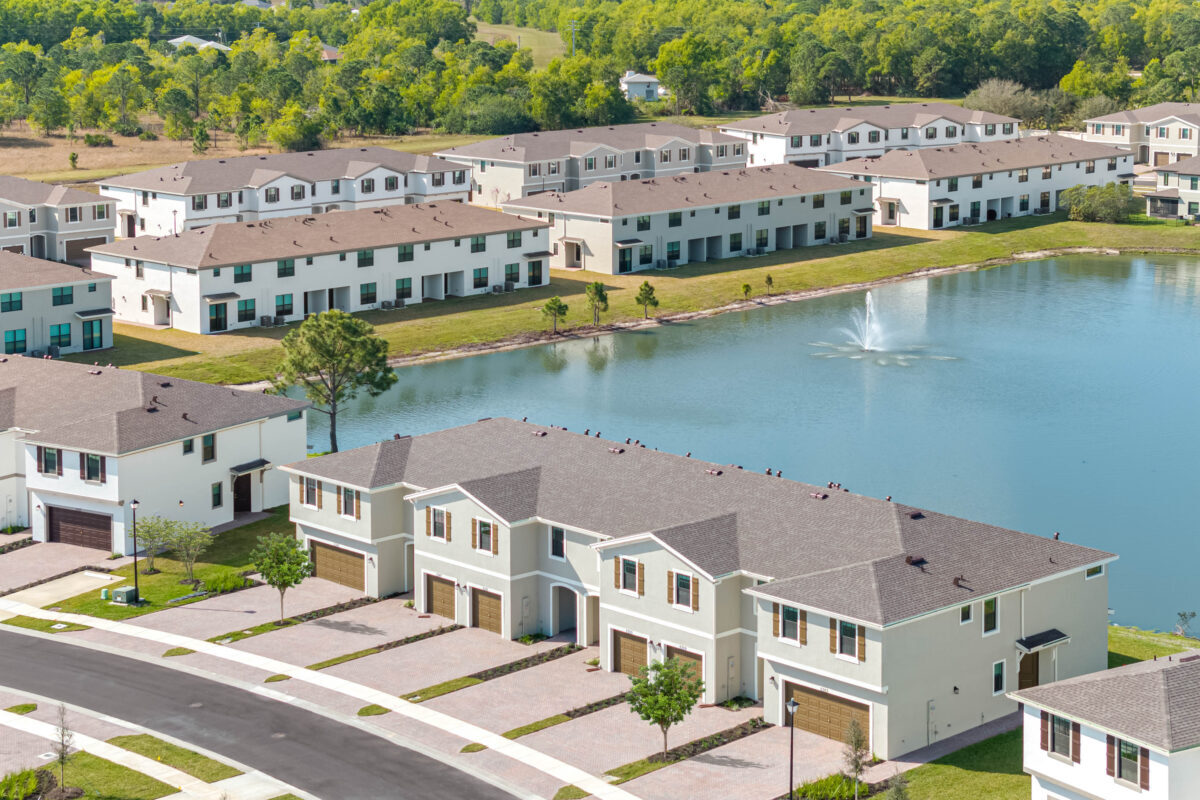 An aerial view of a Kaufman Development community with a lakefront amenity