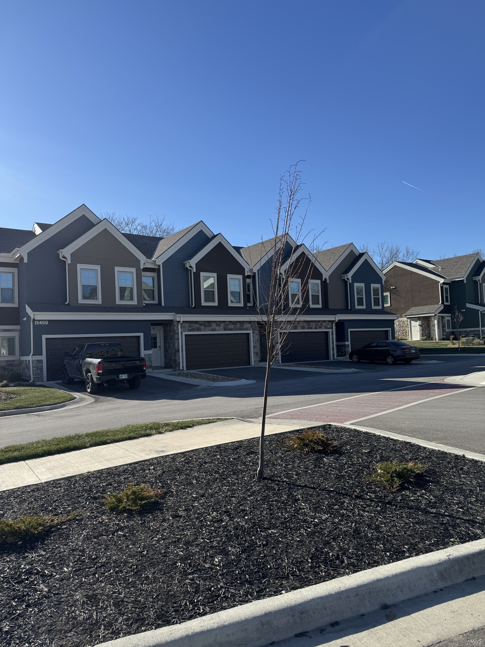 A row of Lonestar Kaufman townhomes with attached garages along the street
