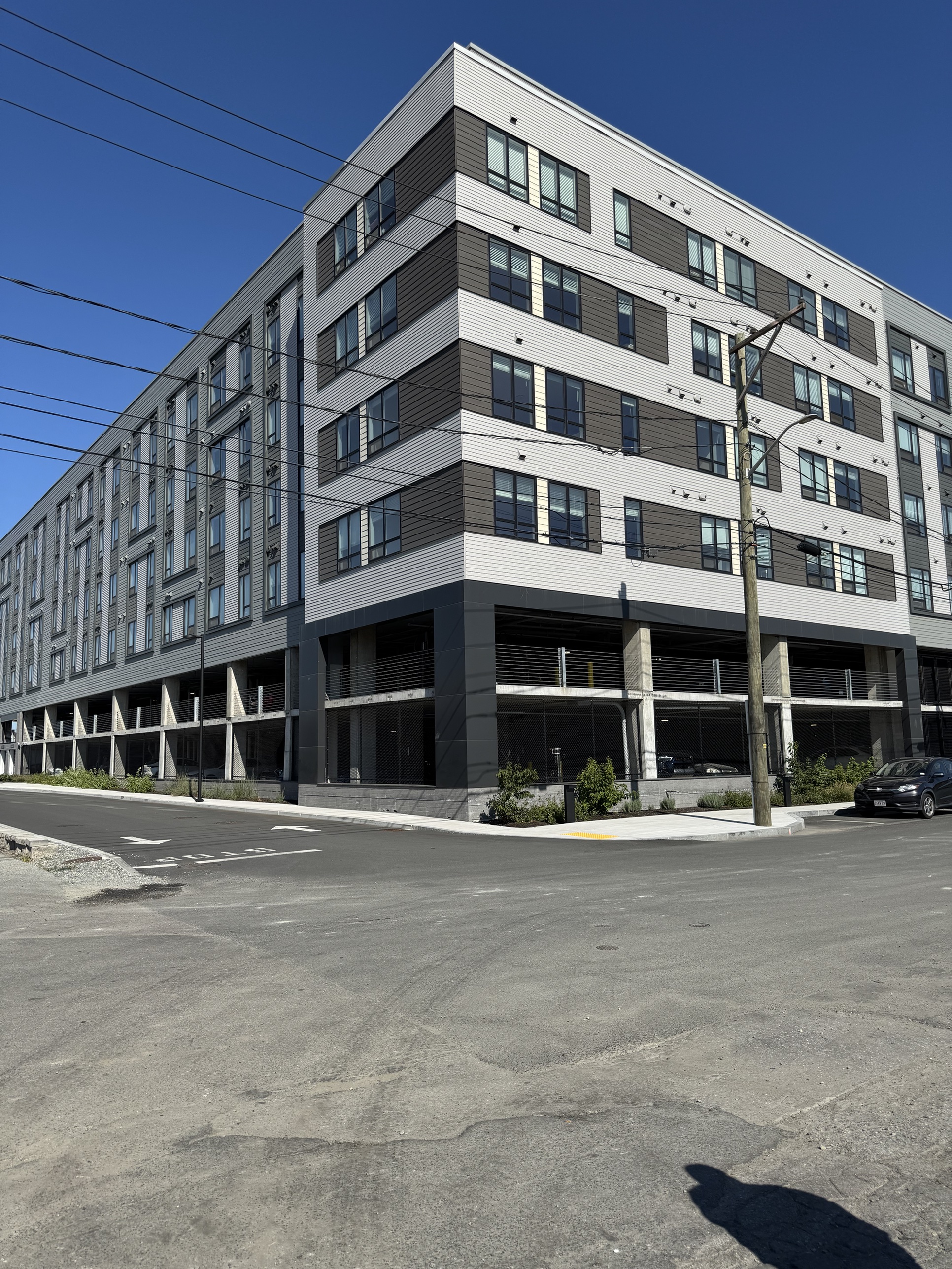 A completed multifamily building with ground-floor parking in a Prophesy Capital target market