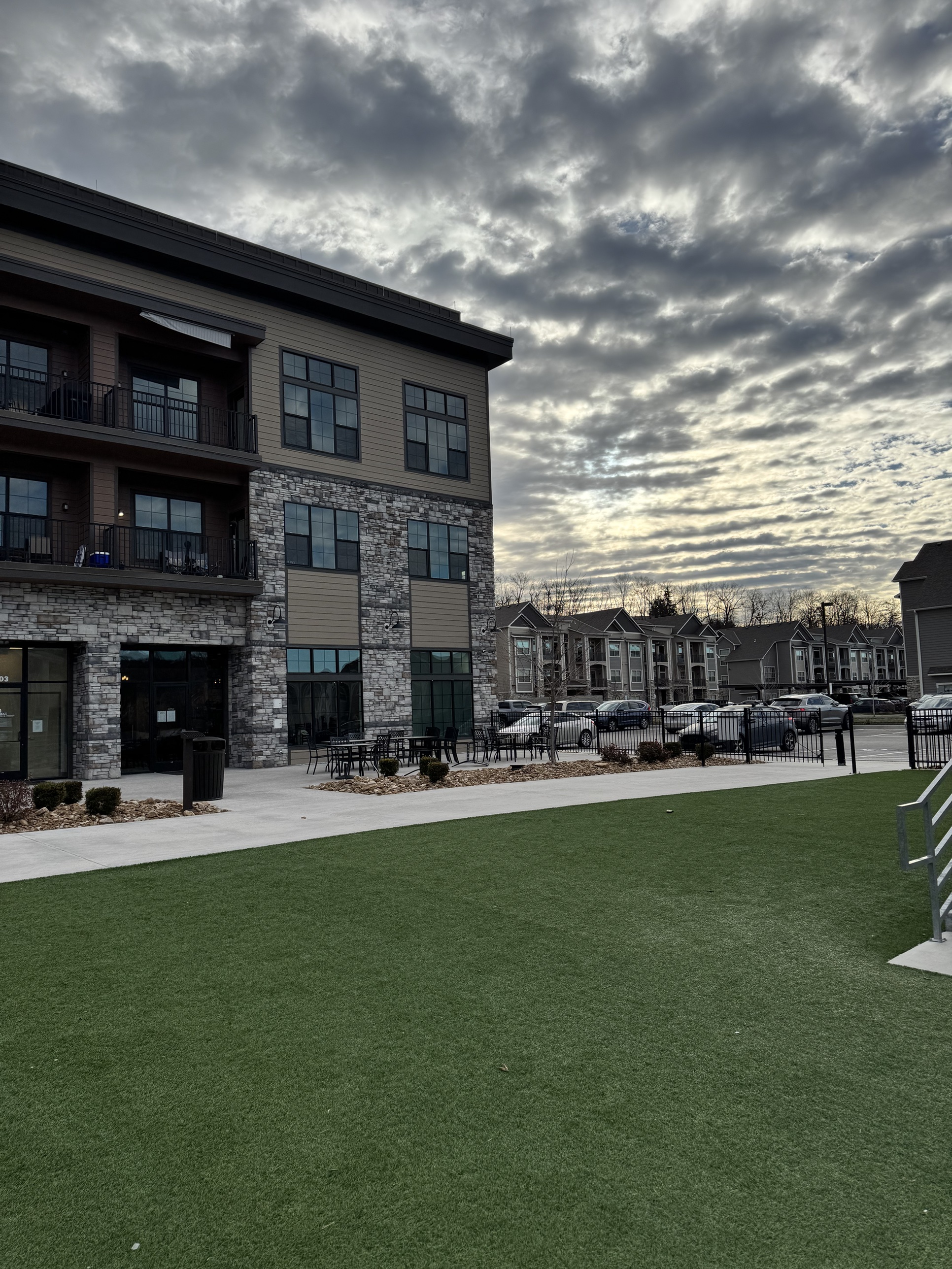 A mixed-use community clubhouse and courtyard at dusk in a Prophesy Capital target market