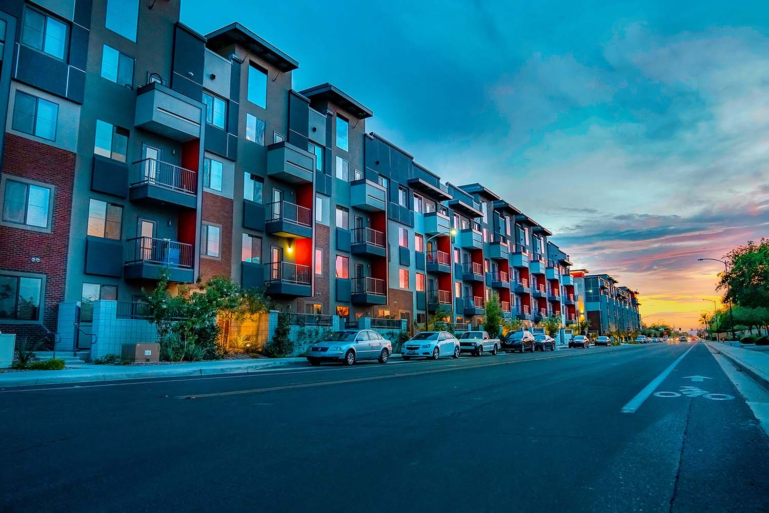 Street-level apartment buildings at sunset in a Prophesy Capital target market