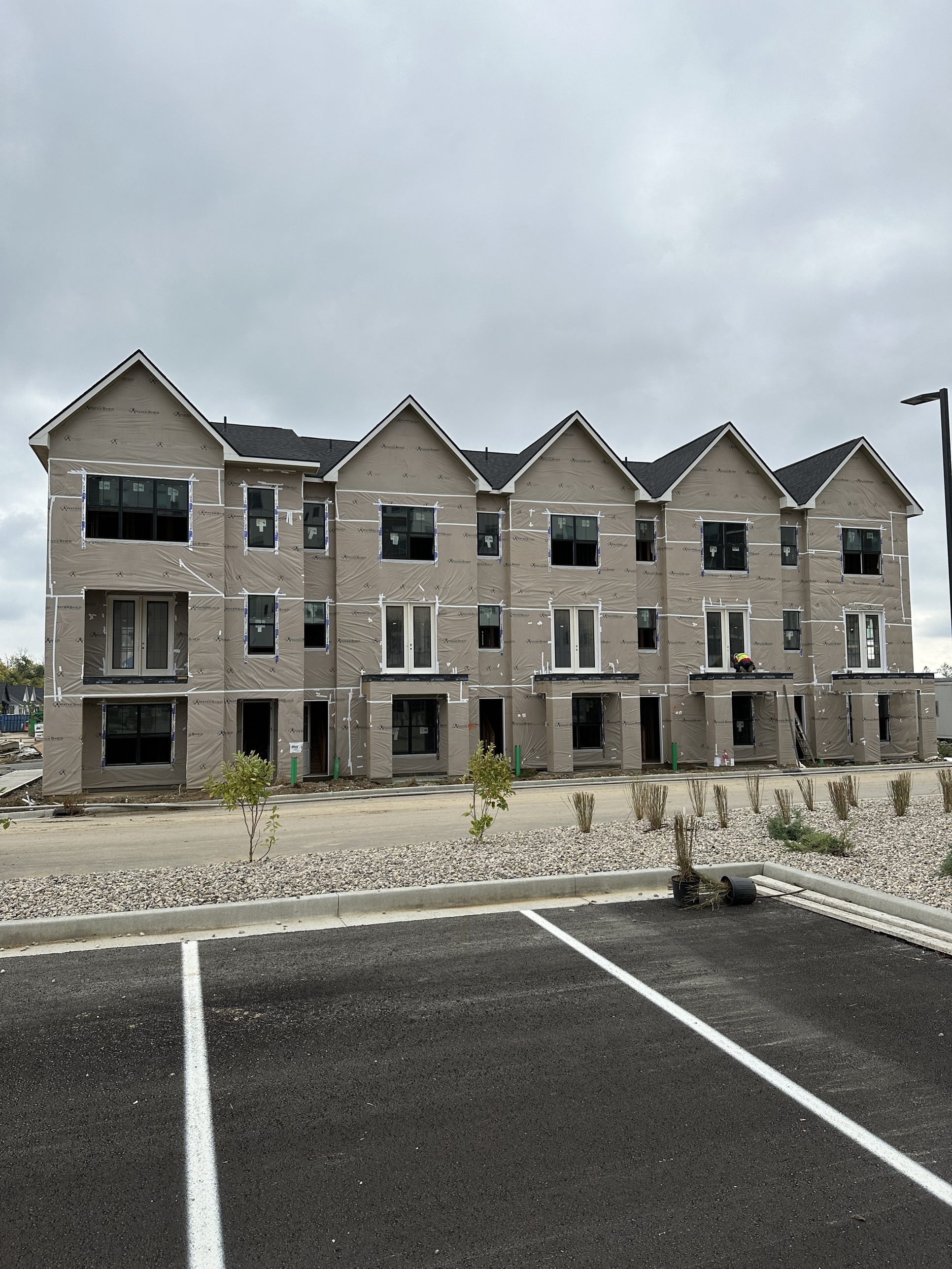 Townhomes under construction wrapped in house wrap in a Prophesy Capital target market
