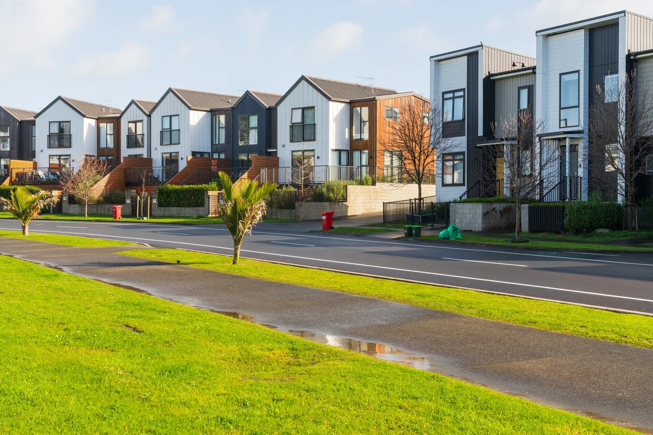 Modern suburban houses with green lawns