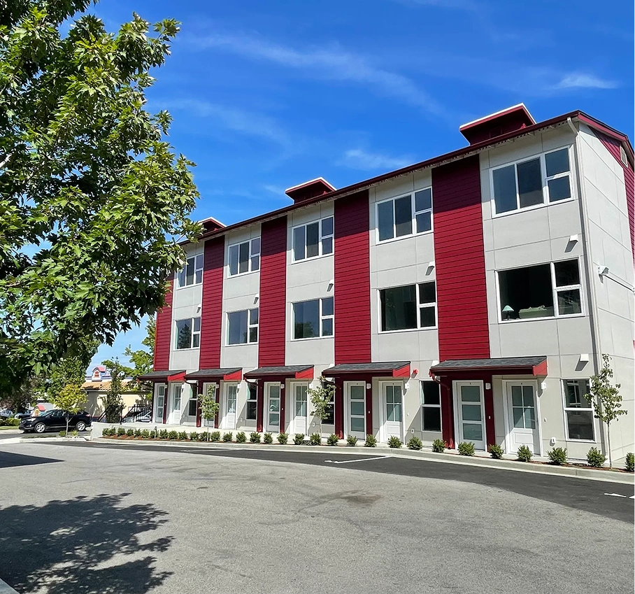 Modern townhouse exterior with red accents
